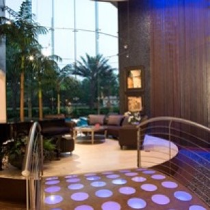 contemporary living room with concrete and glass bridge underlit with fiber optics
